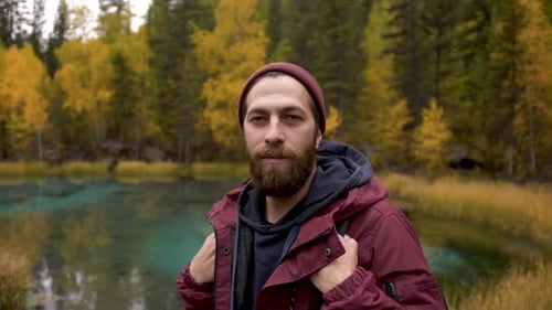 Portrait Young Smiling Man Standing in Forest And Enjoys The Wild Nature Closeup