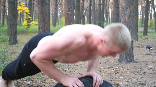 Strong and Muscular Man Doing Push Ups in Forest Male Sportsman Exercising at Nature Athletic Guy