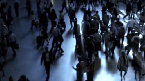 crowd of people walking on busy street at rush hour time