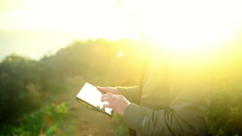 Nature, mountain and man with tablet online for adventure, holiday and vacation for hiking outdoors