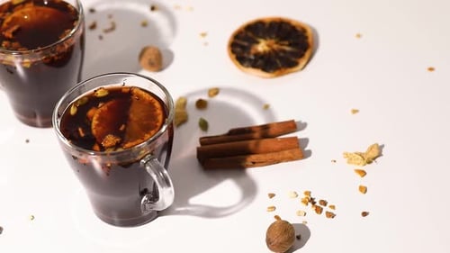 Rotation cup with Christmas mulled red wine with spices and oranges