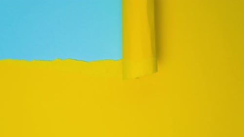 Video Banner with Ripped Paper Abstract Torn Paper Video in Yellow and Blue Colors with Copy Space