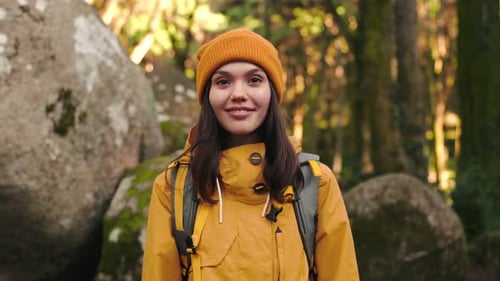 Joyful Hiking Adventure Woman in Yellow Hat Smiling in Green Forest
