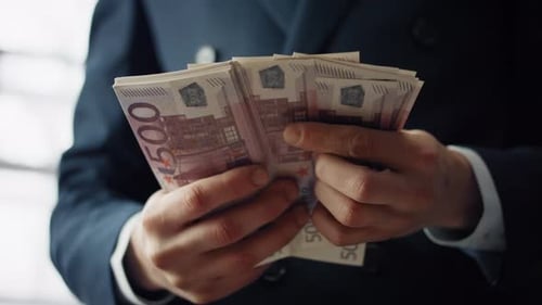 Closeup Man Hands Counting 500 Euro Money Bills in Modern Office. Unknown
