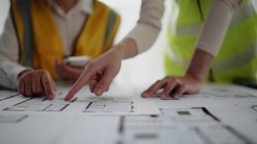 Close up of hands working for cost estimating for architectural and engineering.