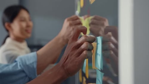 Asia businesspeople stand behind transparent glass wall listen manager pointing progress work.