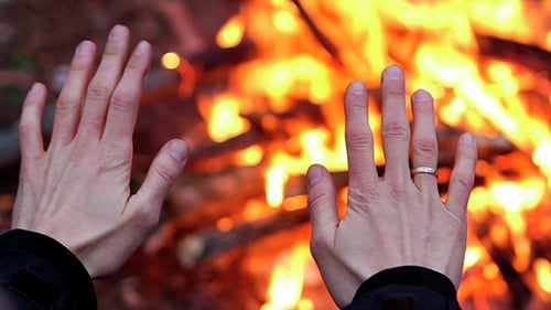 Man Is Heated By The Fire