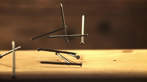 Nails Fall on a Wooden Table