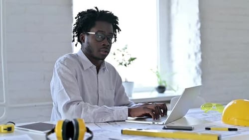 Thumbs Down By African Engineer at Work