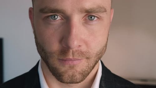 Portrait of Handsome Young Business Man with a Beard Looking at Camera. Close Up of the Face.