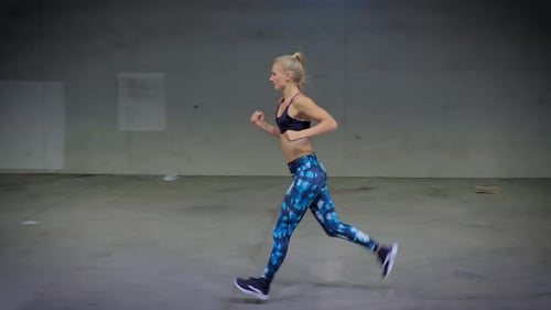 Attractive Woman Jogging Through A Tunnel
