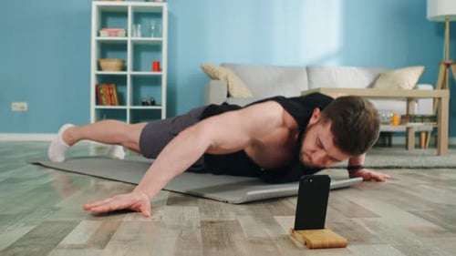 Strong Man Uses Online Application To Train at Home
