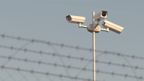 Security drones Modern surveillance technology flying behind barbed wire.