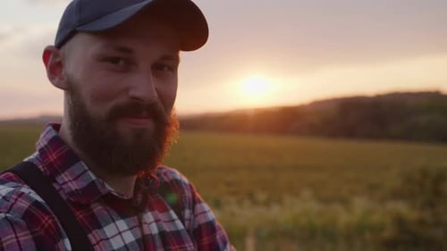 Handsme Man Smiles and Watches on the Camera
