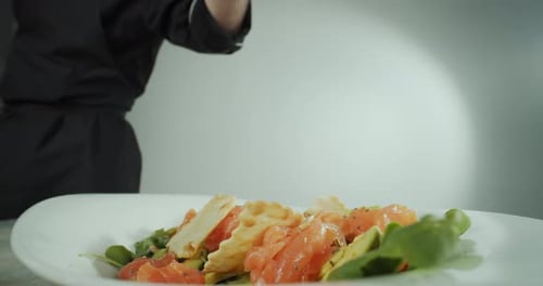 Close Up Shot of a Man Hand Chef Prepares a Salad of Seafood and Vegetables