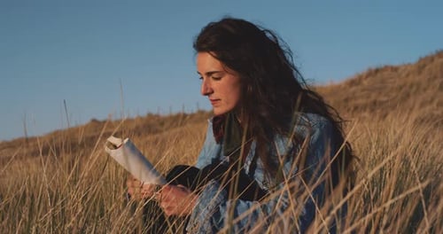 Attractive young caucasian woman reading a book