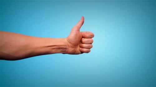 Thumbs Up Gesture On Blue background
