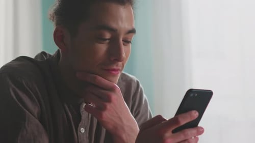 Young Man Looks Through Social Media News