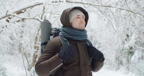 Portrait Happy Male Traveler Backpacker Standing in Winter Forest Smiling and Looking Around
