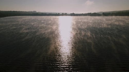 Drone Flight Over a Lake in the Morning at Sunrise