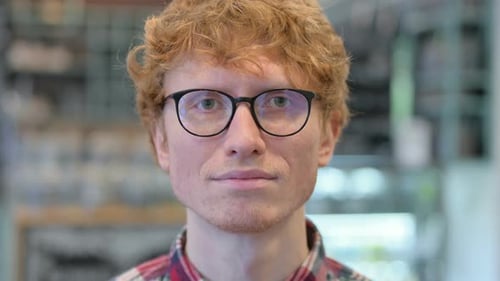 Close Up of Serious Young Redhead Man Looking at the Camera