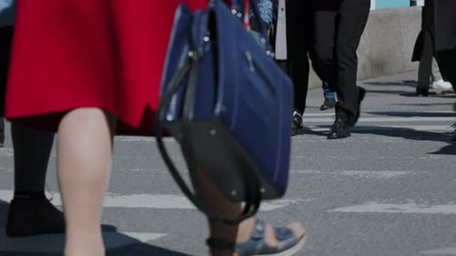 people are walking down the street on a pedestrian crossing