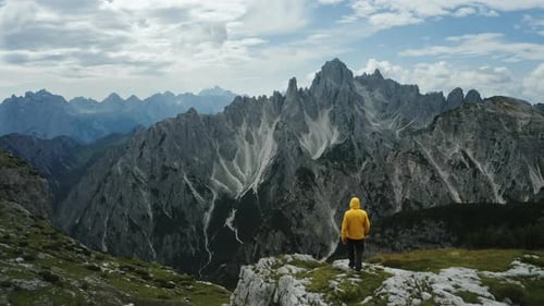 Aerial View of Man in Yellow Coat in Front of Auronzo Di Cadore of Cadini Di Misurina Mountains