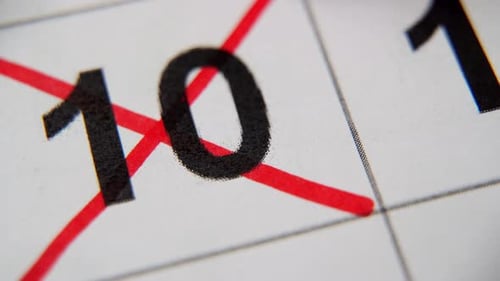 The 10St Number in the Calendar is Crossed Out with a Red Cross in a Macro on a White Sheet