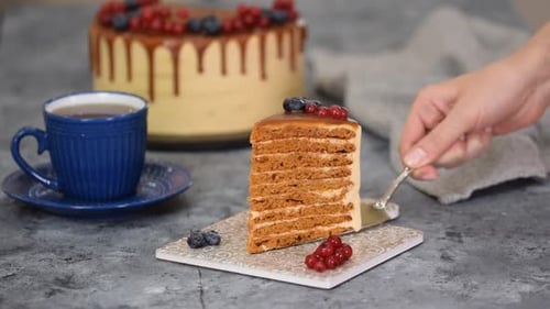 Piece of Layer Caramel Cake with Cream and Fresh Berries