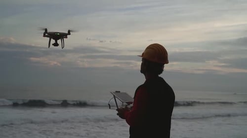Male engineer doing inspection using drone - Technology and industrial concept