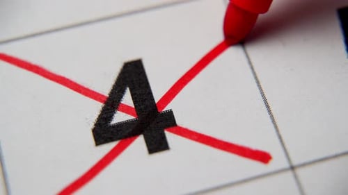 The 4St Number in the Calendar is Crossed Out with a Red Cross in a Macro on a White Sheet